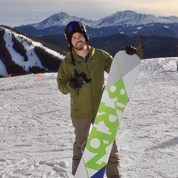 CORE employee, Dave Branz, posing with snowboard on the mountain