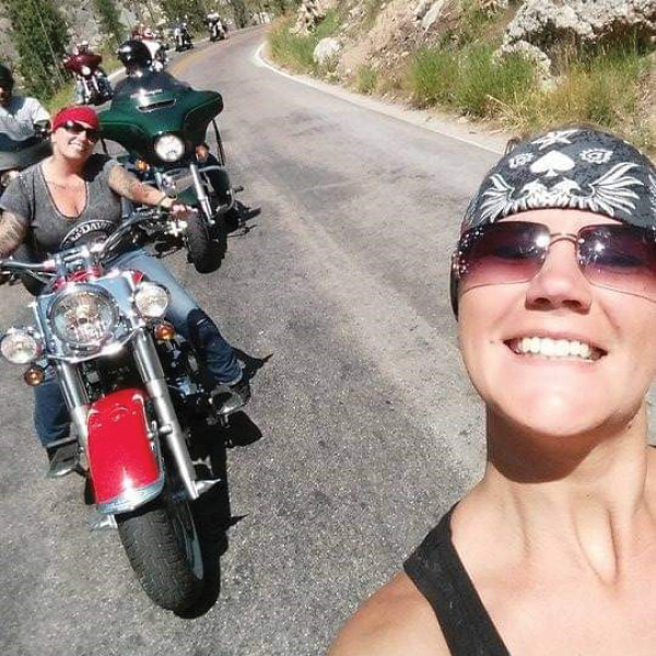 CORE employee, Jana Passafiume, on a motorcycle next to a woman on a motorcycle