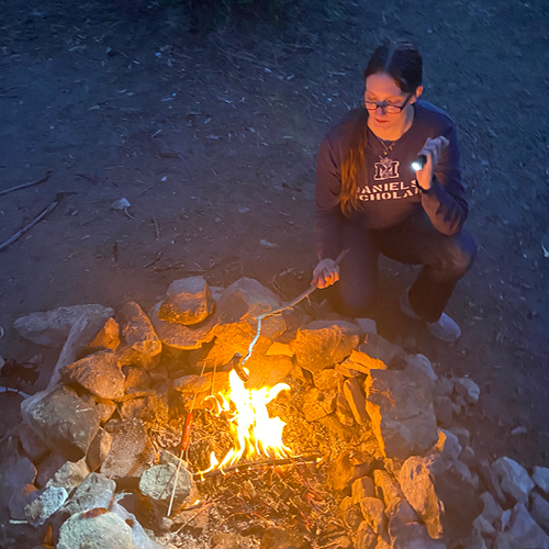 CORE employee, Jess Kordziel, at a campfire