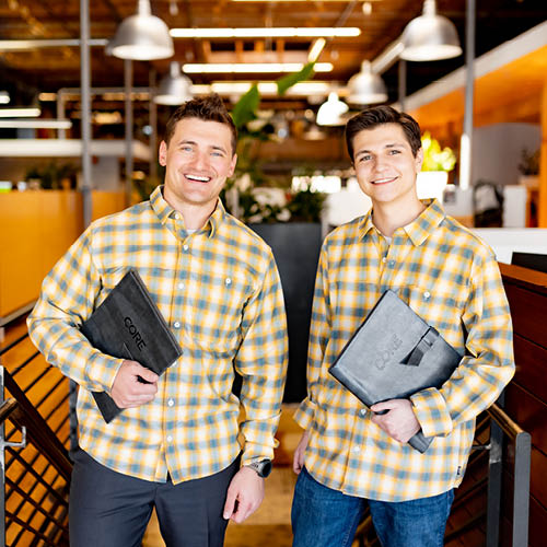two employees wearing matching outfits in the office